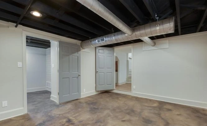 Downstairs living space with exposed ceiling