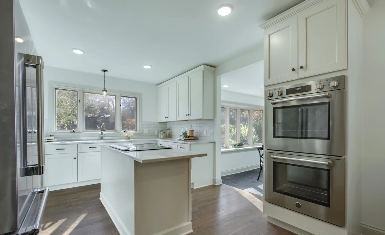 White kitchen with built-in oven and center peninsula