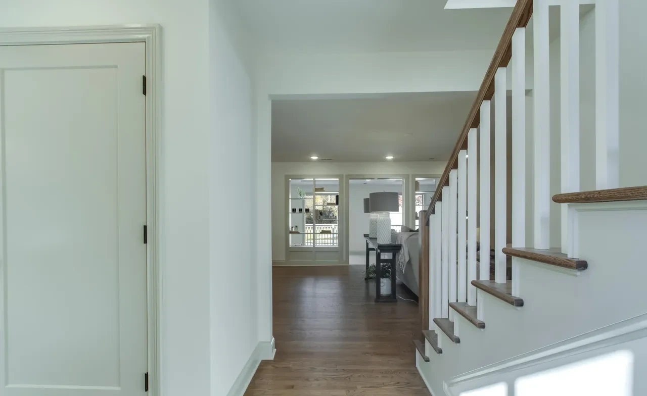 Entry hallway with staircase and wood floors